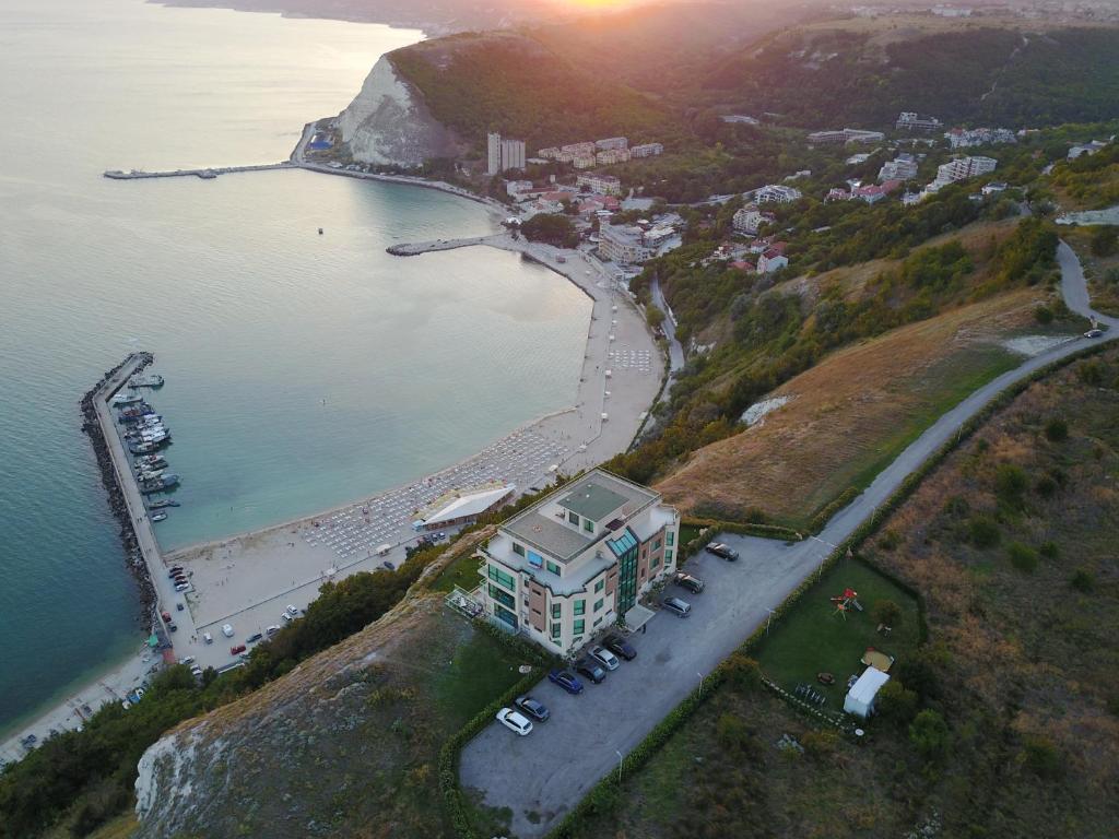 an aerial view of a building on a hill next to a beach at Calithea Complex in Kavarna
