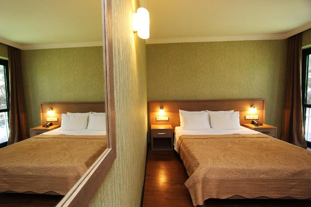 Postel nebo postele na pokoji v ubytování Batesta Hotel