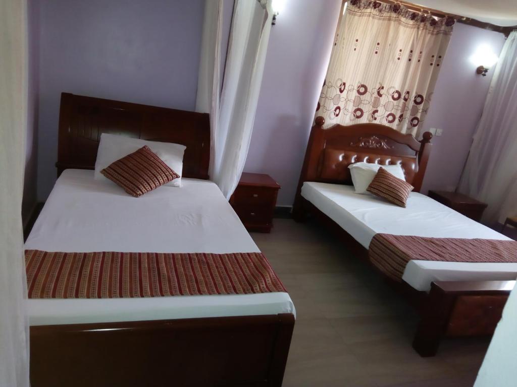 Postel nebo postele na pokoji v ubytování Lambada Holiday Resort Mombasa