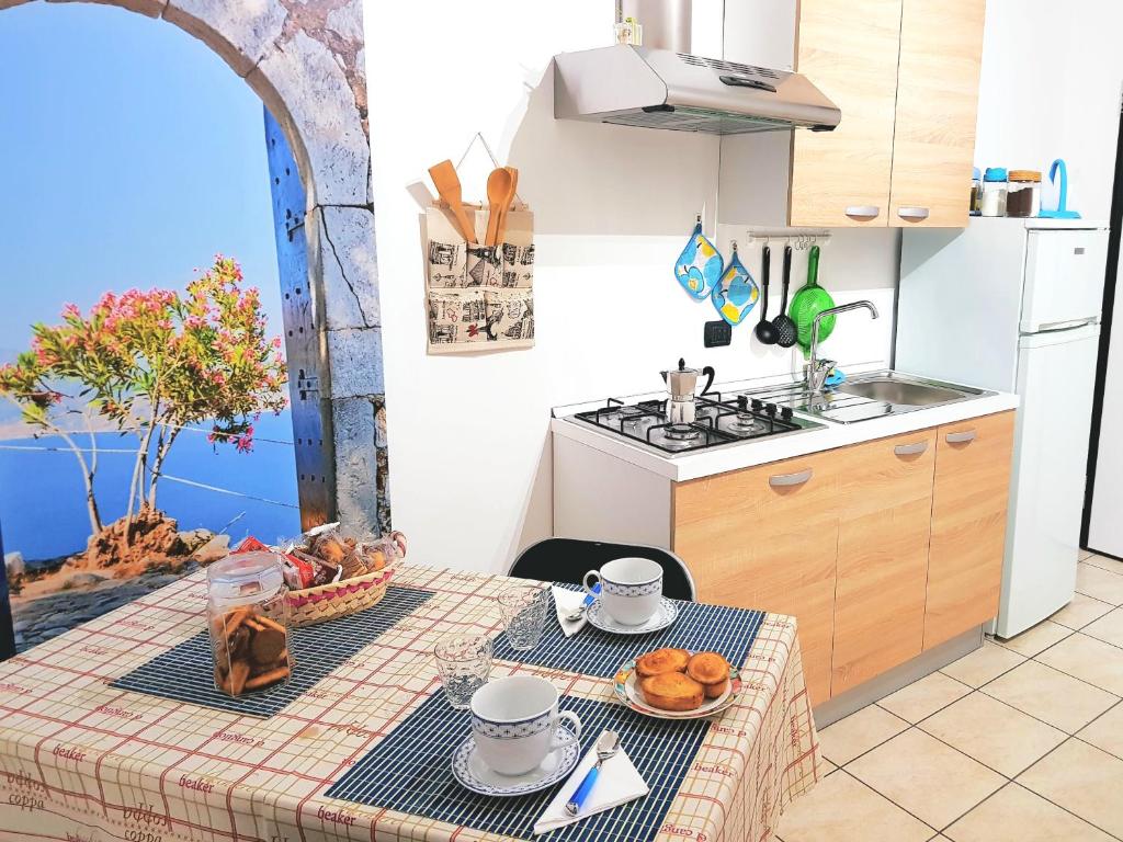 a kitchen with a table with food on it at Salento Holiday Casa Vacanze in Magliano