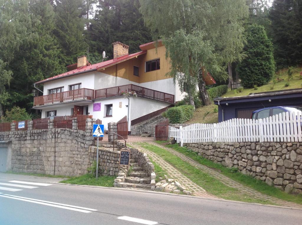 a house on a hill with a stone wall at Villa Retro in Karpacz
