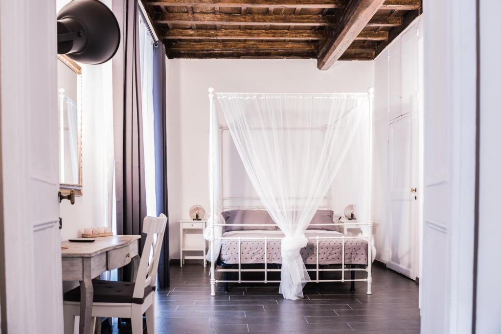 a bedroom with a bed with a canopy at Pantheon116 in Rome