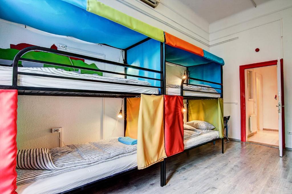 a room with a bed, bunk beds, and a window at Pal's Mini Hostel in Budapest