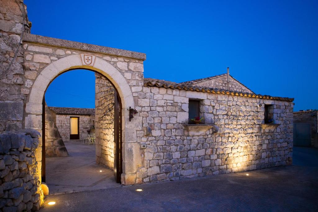 an entrance to a stone building with an arch at Casale del Coccio in Scicli