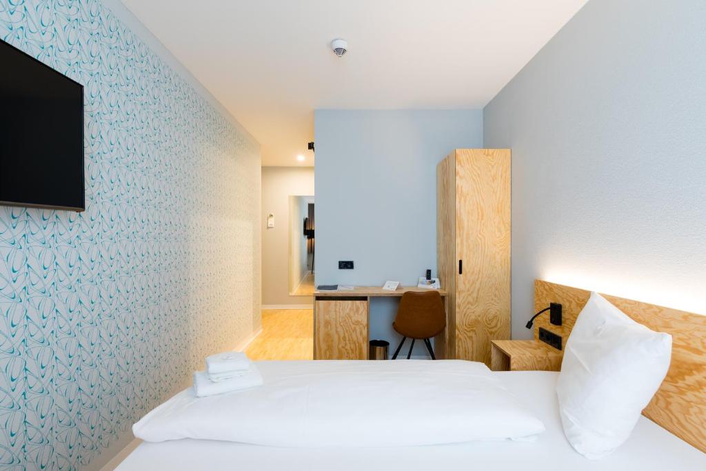 Postel nebo postele na pokoji v ubytování mk | hotel münchen city