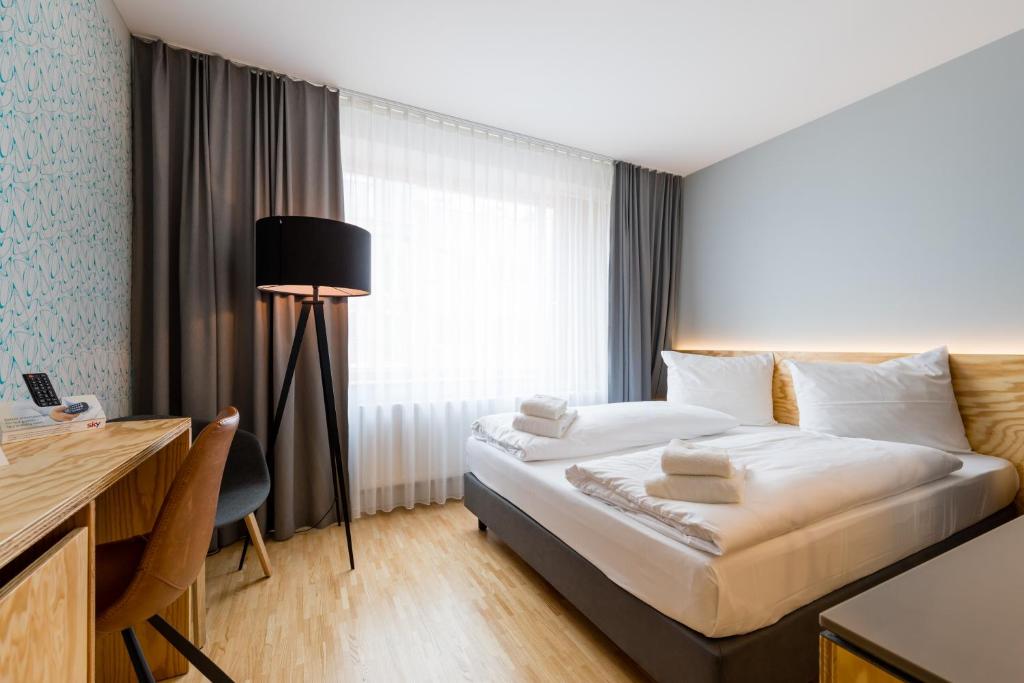Postel nebo postele na pokoji v ubytování mk | hotel münchen city