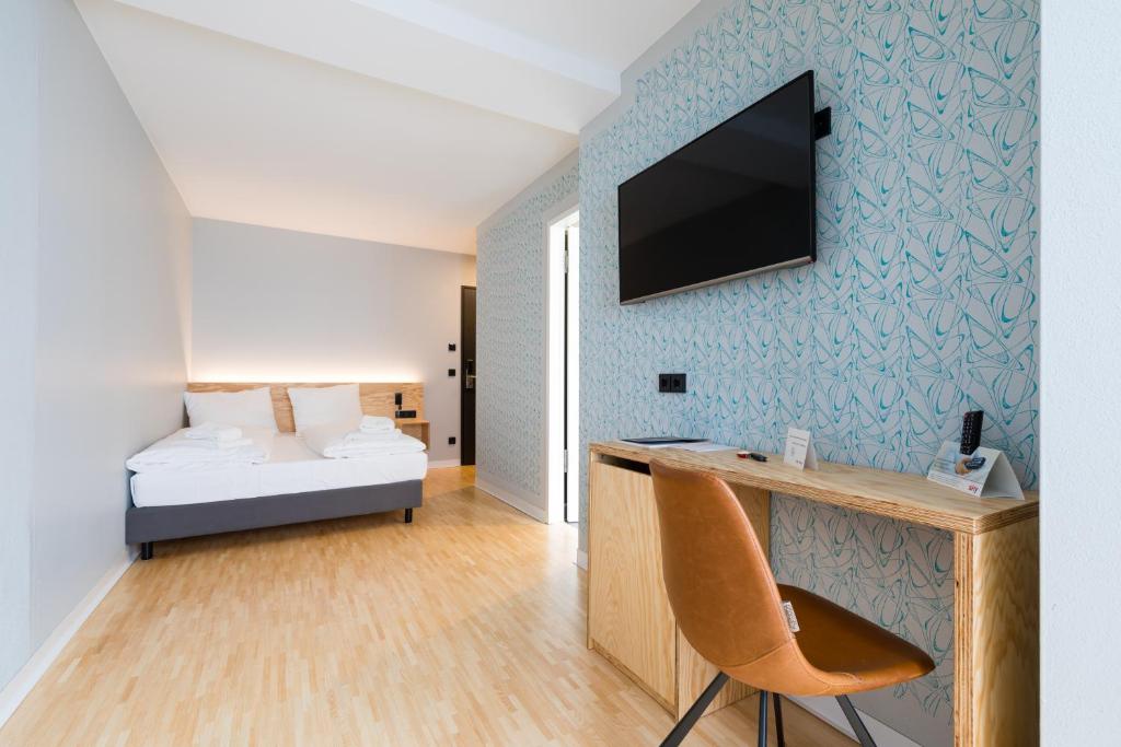 TV a/nebo společenská místnost v ubytování mk | hotel münchen city