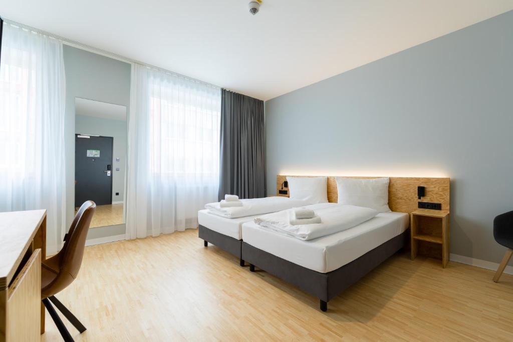 Postel nebo postele na pokoji v ubytování mk | hotel münchen city
