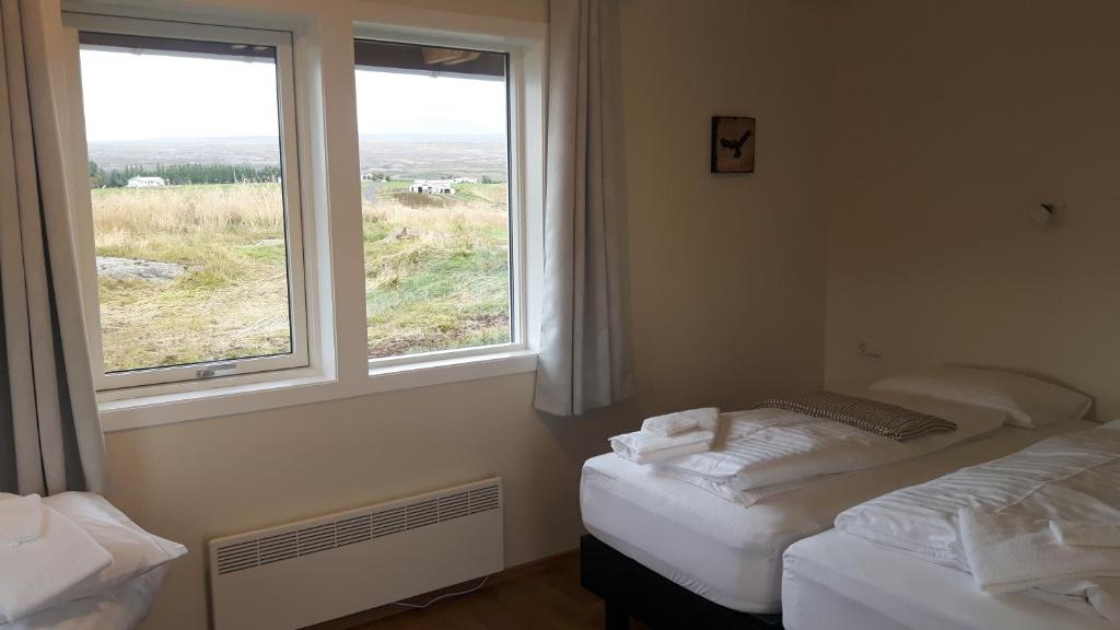 Rúm í herbergi á Hjartarstaðir Guesthouse