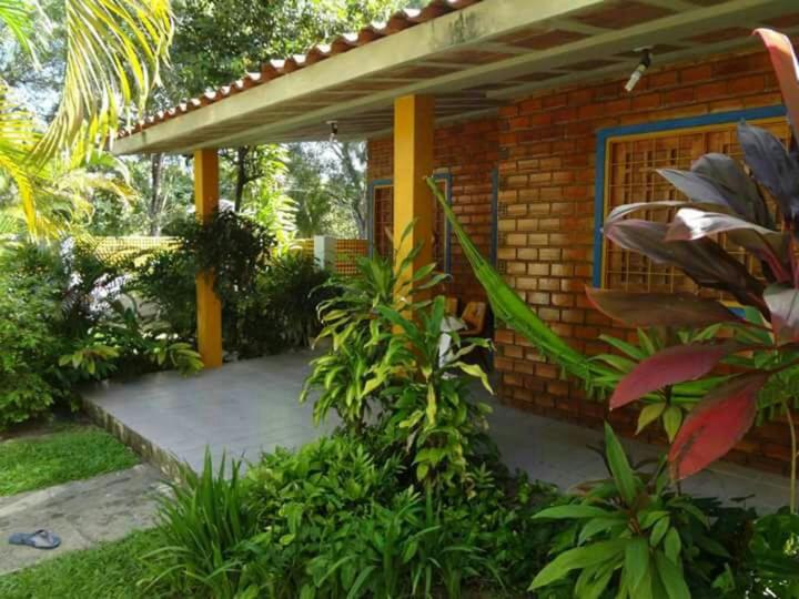 ポルト・デ・ガリーニャスにあるPrive das Acaciasのレンガ造りの家で、正面にパティオがあります。