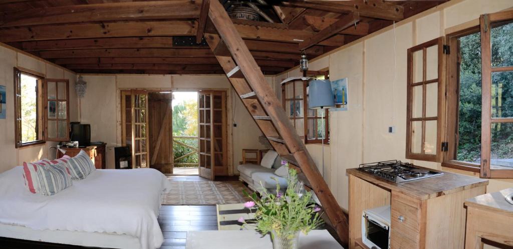 a living room with a staircase in a tiny house at Ha Mar ao Luar in Setúbal