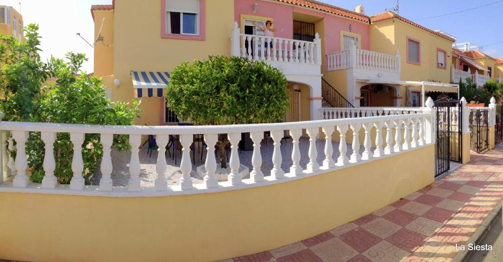 einen weißen Zaun vor einem Haus in der Unterkunft La Siesta in Torrevieja