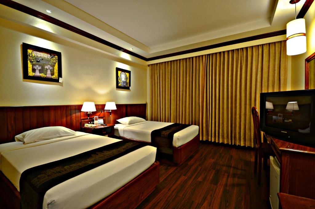Postel nebo postele na pokoji v ubytování City River Hotel