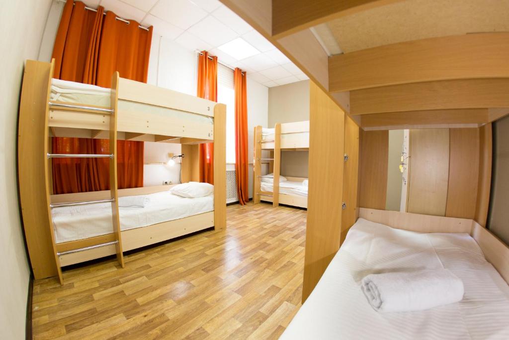 two bunk beds in a room with wooden floors at Z Hostel in Irkutsk