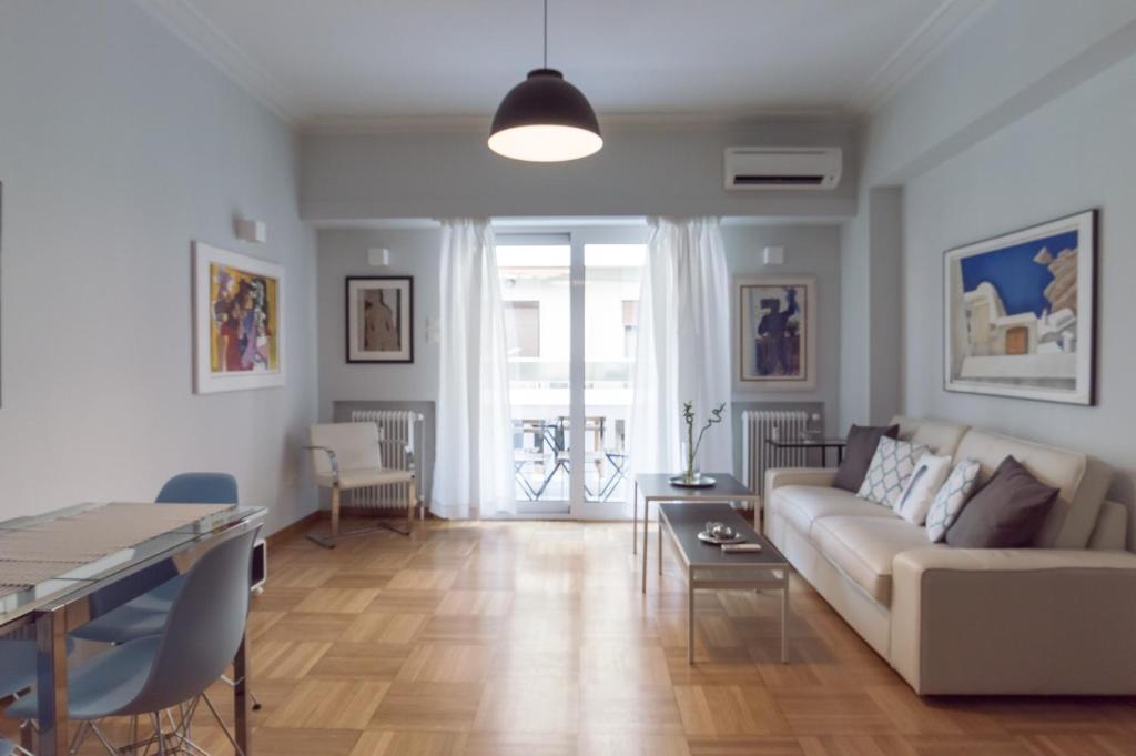 a living room with a couch and a table at Athens Squared Apartments in Athens