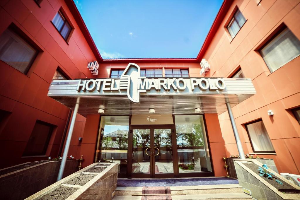 Marko Polo Hotel في Aksay: فندق فيه لافته على واجهة مبنى