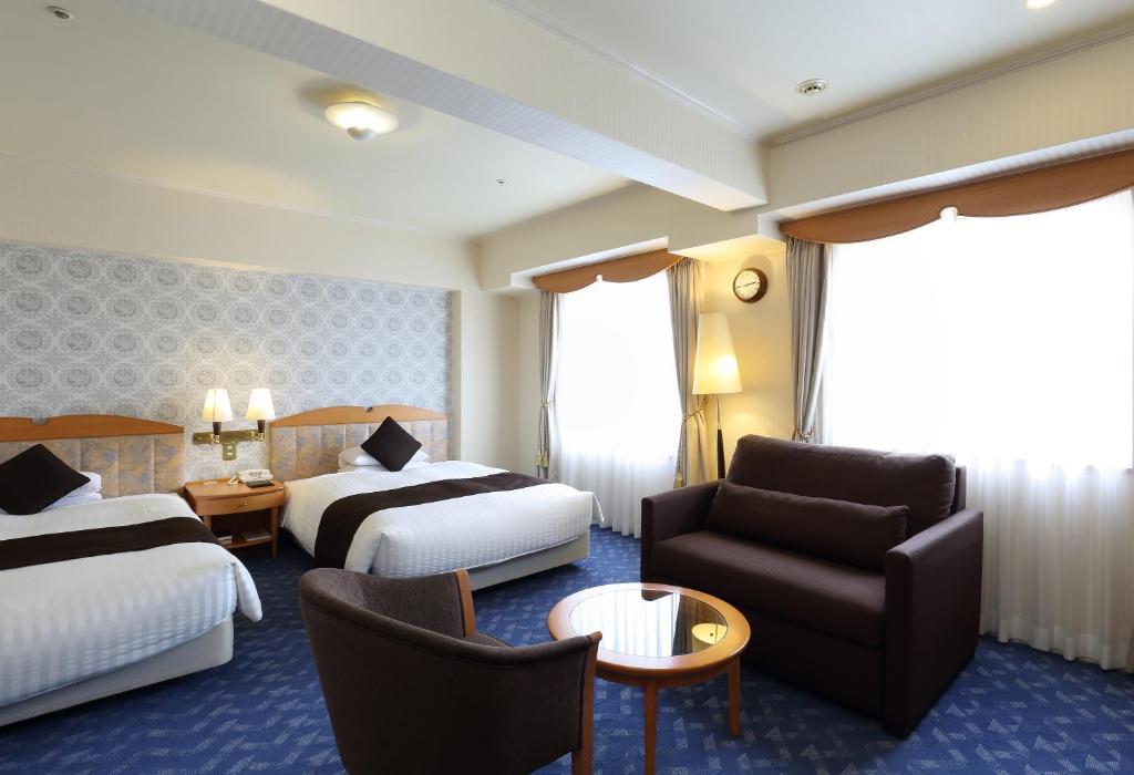Postel nebo postele na pokoji v ubytování Nishitetsu Grand Hotel