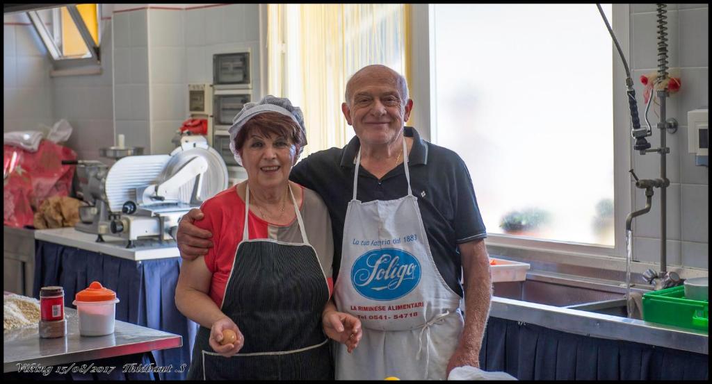 a man and a woman standing in a kitchen at Hotel Viking in Rimini
