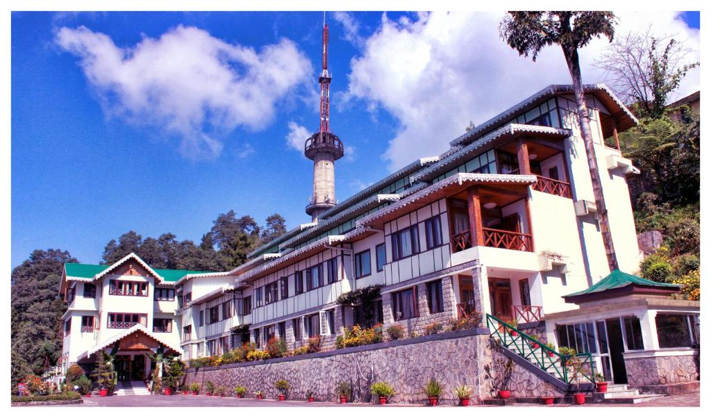 a building with a tv tower on top of it at Zone Connect by The Park Mount Siniolchu, Gangtok in Gangtok