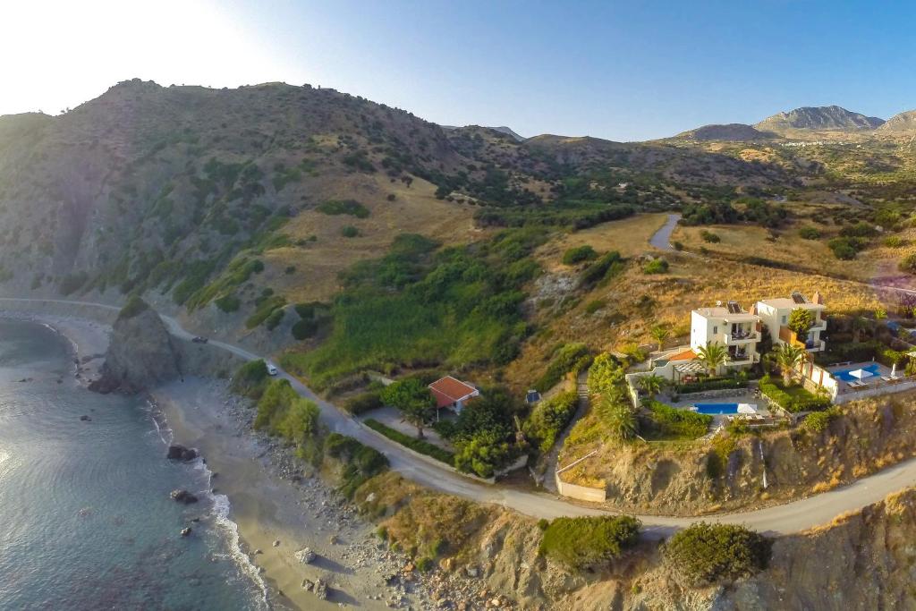 an aerial view of a house on a hill next to the ocean at Chrysa Villa in Kerames