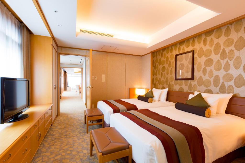 Postel nebo postele na pokoji v ubytování Karuizawa Asama Prince Hotel