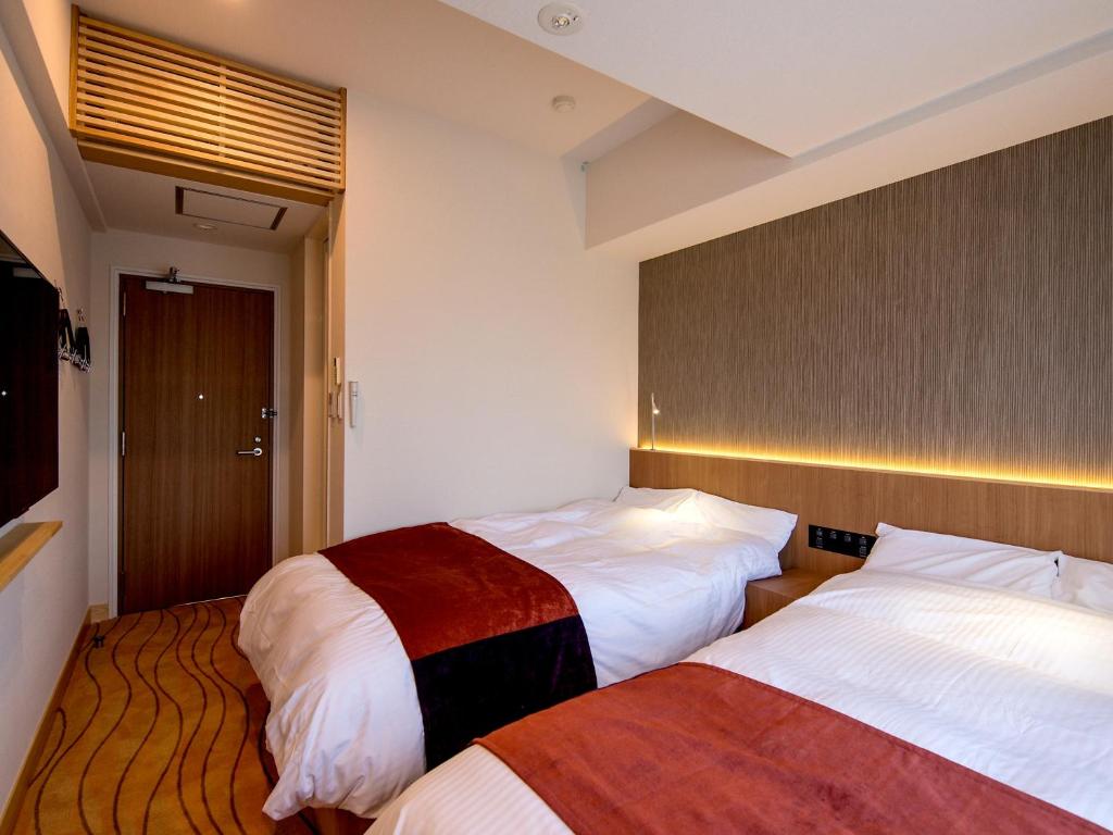 Letto o letti in una camera di TKP Lectore Atami Momoyama