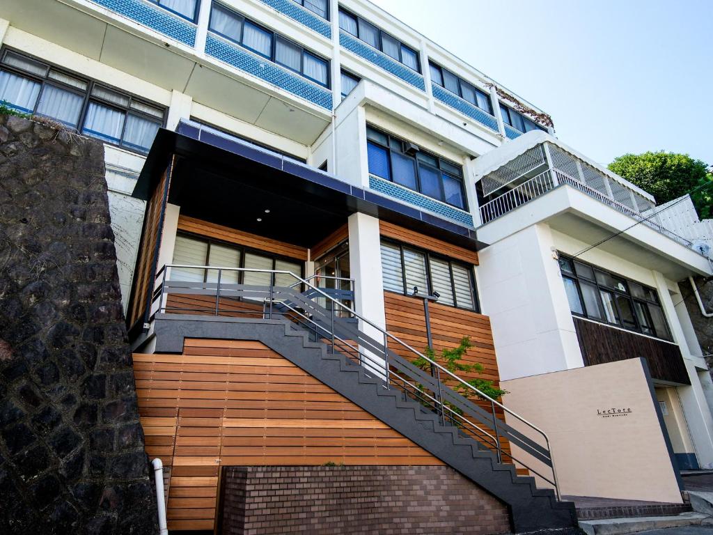 a building with a staircase in front of it at TKP Lectore Atami Momoyama in Atami