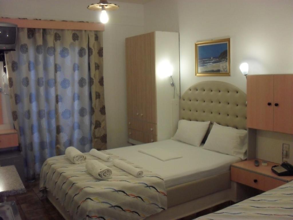 a bedroom with a bed with towels on it at La Santre Villa in Amoudara Herakliou