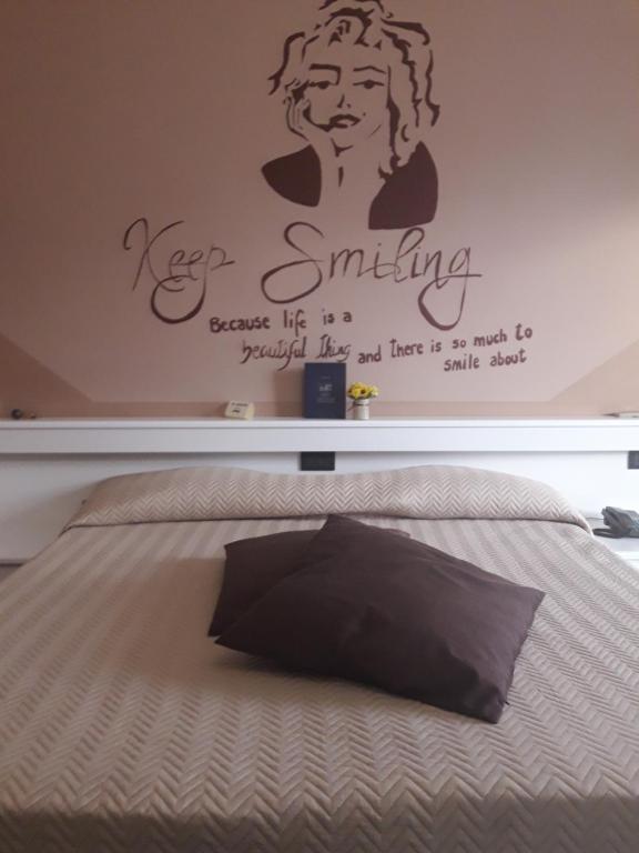 Postel nebo postele na pokoji v ubytování Hotel Stazione sul lago di Iseo
