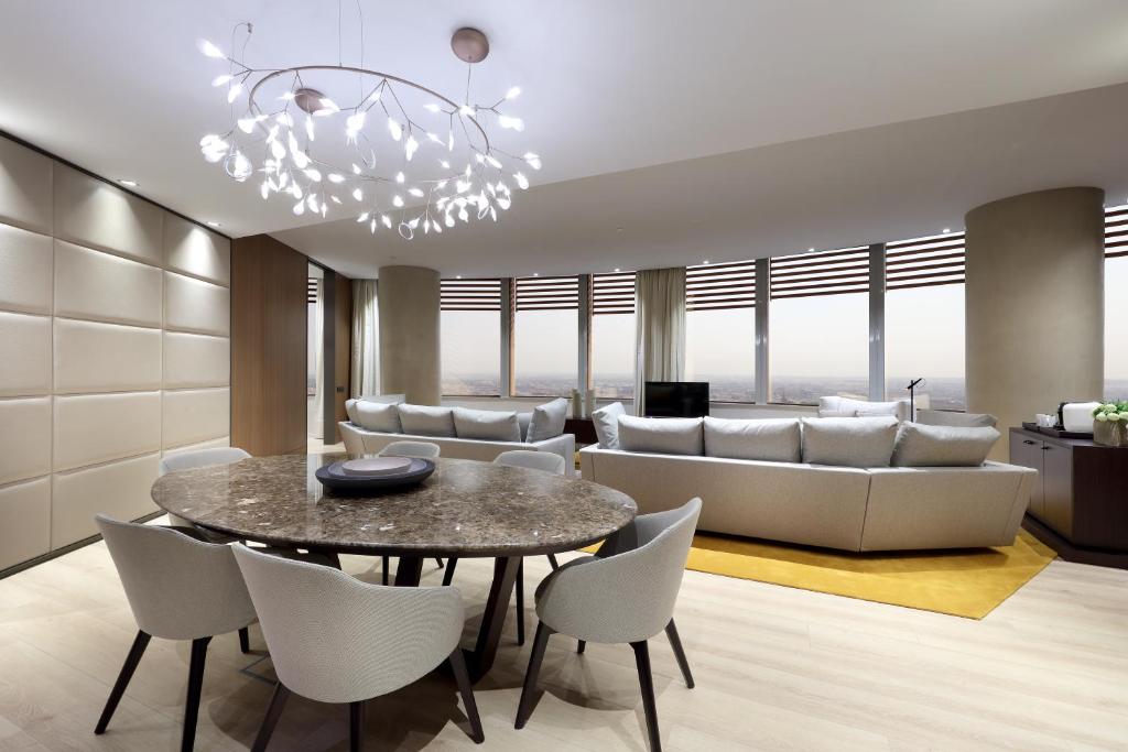 a living room with a table and a couch at Eurostars Torre Sevilla in Seville