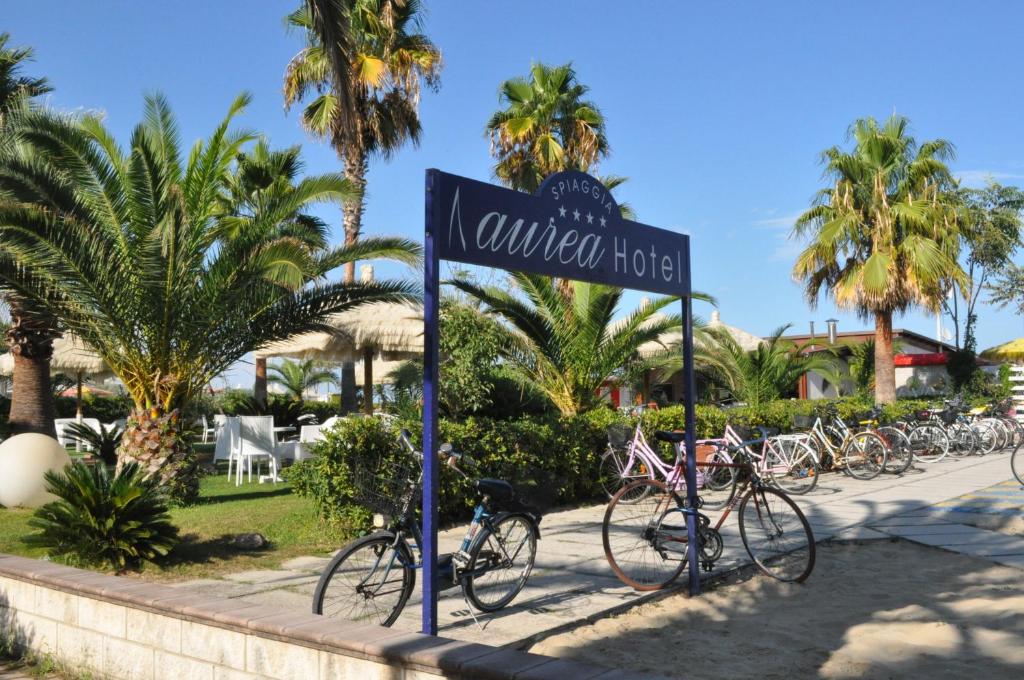 a street sign with bikes parked on a sidewalk at Aurea Hotel in Tortoreto Lido