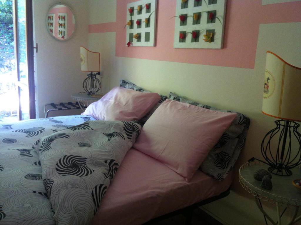a bedroom with a bed with two pillows on it at B&B Le Ortensie -Lago di Como in Lierna