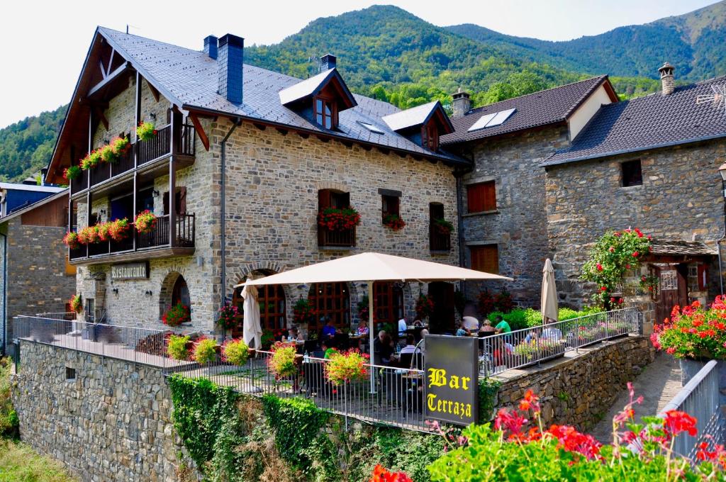 a building with an umbrella in front of it at Casa Montse in Torla-Ordesa