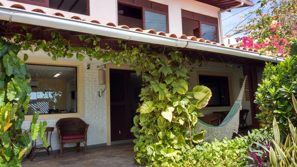 a house with a bunch of ivy growing on it at Pousada Castanheira in Natal