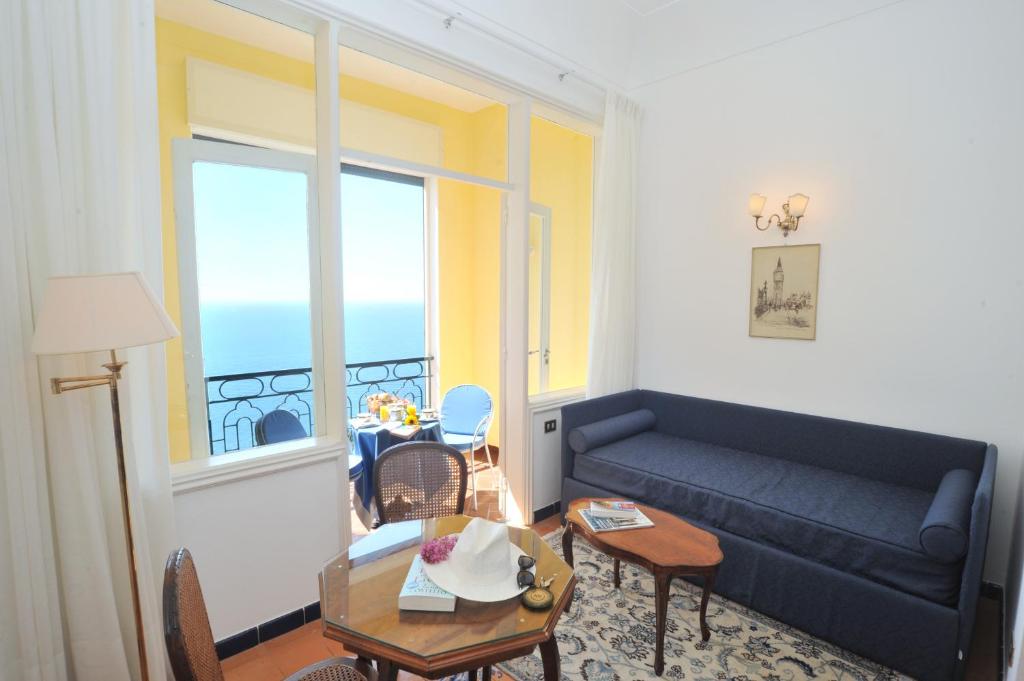 a living room with a couch and a table at Hotel Belvedere in Conca dei Marini