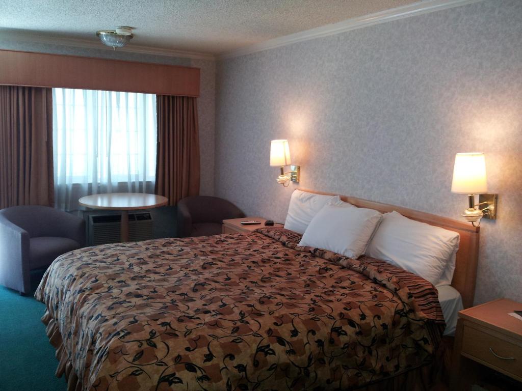 a hotel room with a large bed with white pillows at Castle Inn in San Francisco