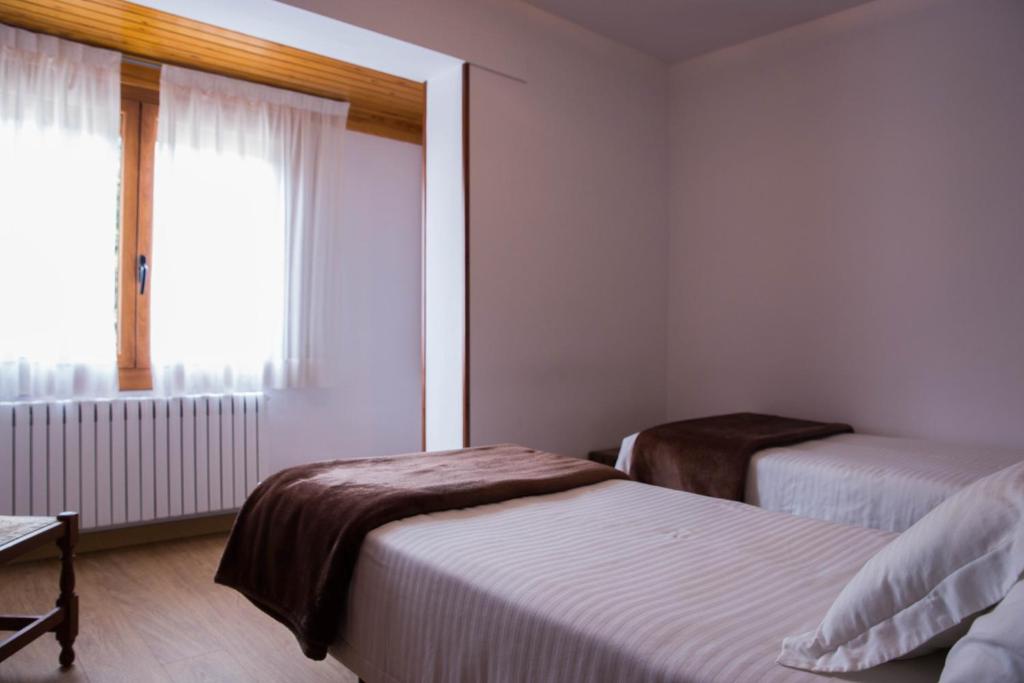 Postel nebo postele na pokoji v ubytování Hotel Bruna