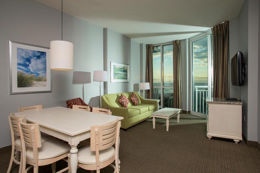 a living room with a table and a couch at Avista Resort in Myrtle Beach