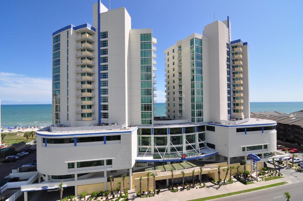 a group of tall buildings next to the ocean at Avista Resort in Myrtle Beach