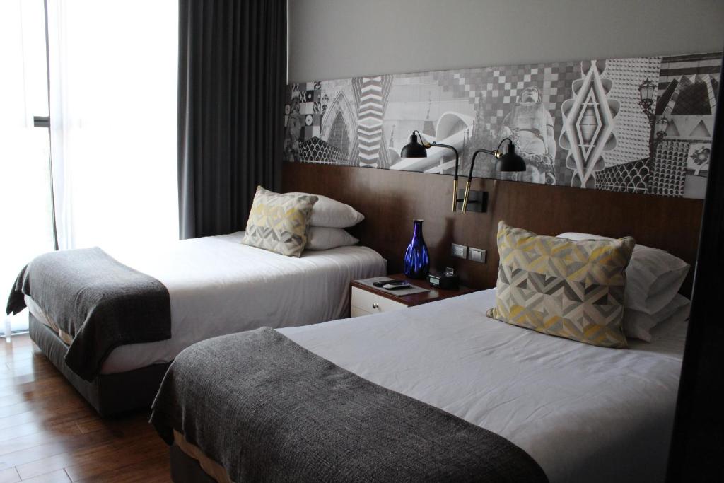 Postel nebo postele na pokoji v ubytování Hotel Love It CAS Consulado