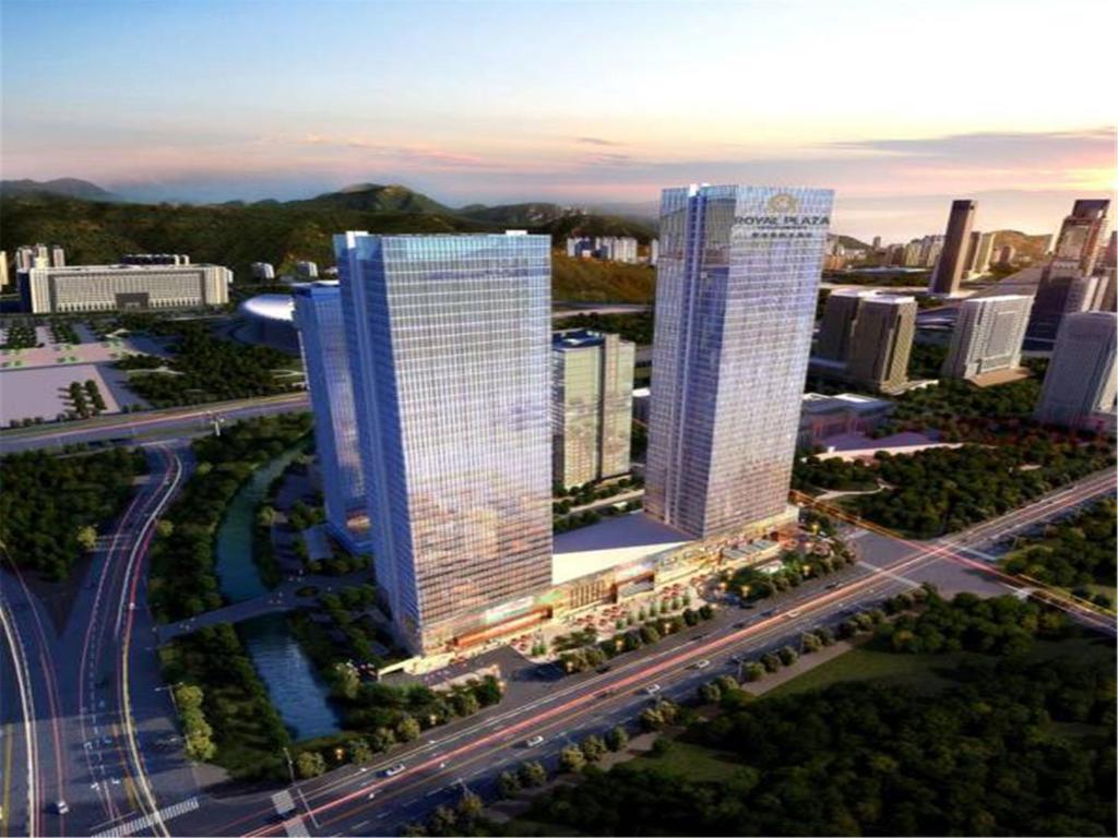 two tall buildings in a city with a highway at Jinan Inzone Royal Plaza Hotels in Jinan