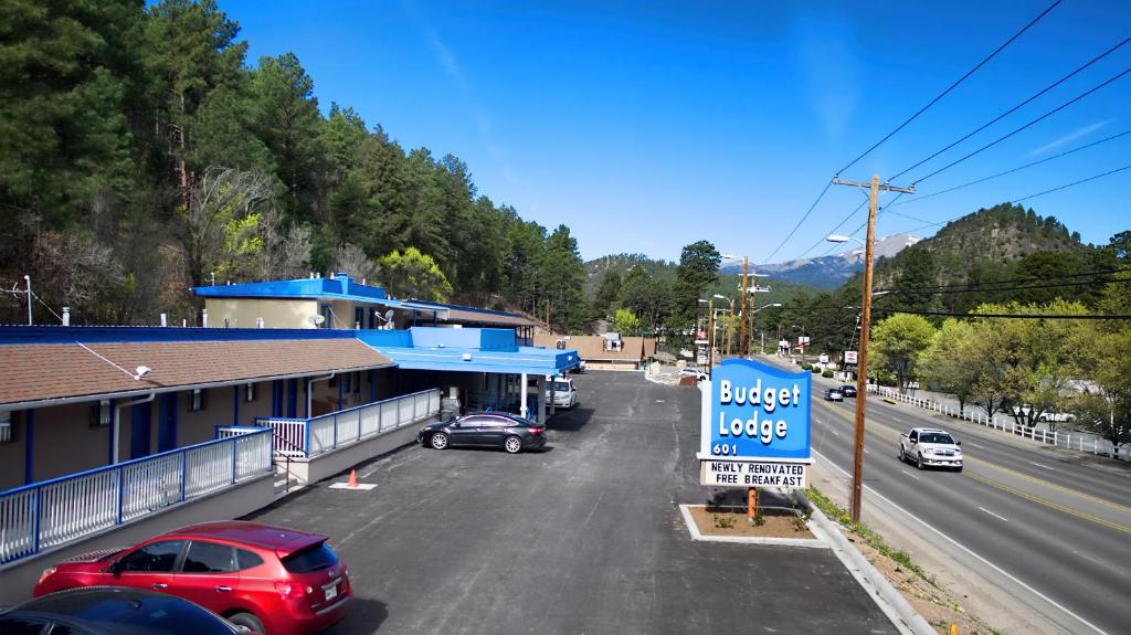 a building with a sign for a trucking garage at Budget Lodge in Ruidoso