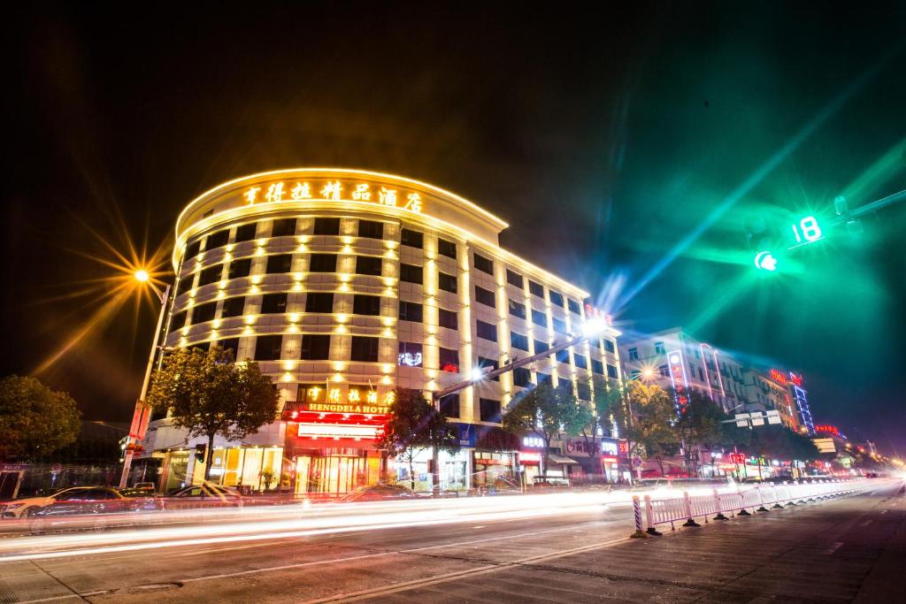 a building on a city street at night at Hendra Hotel in Wenzhou