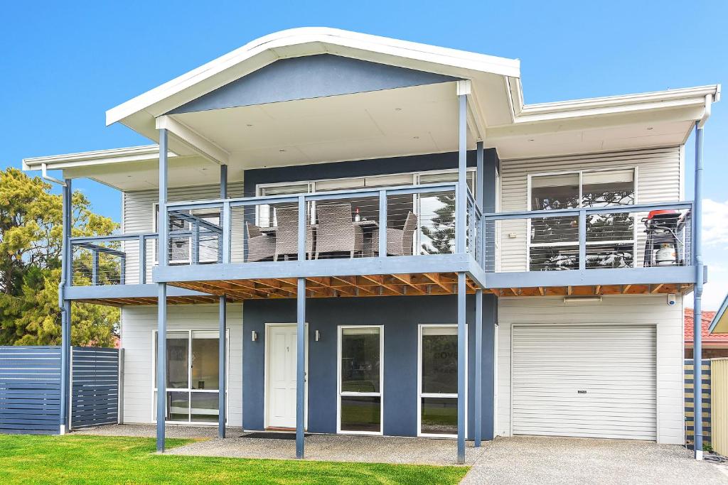 a large house with a balcony on top of it at 'Hope House' - Encounter Bay in Kilki