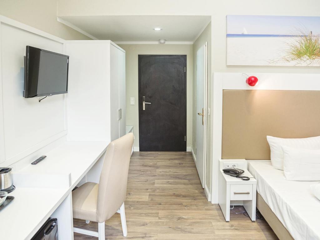 Televízia a/alebo spoločenská miestnosť v ubytovaní Hotel Domicil Hamburg by Golden Tulip