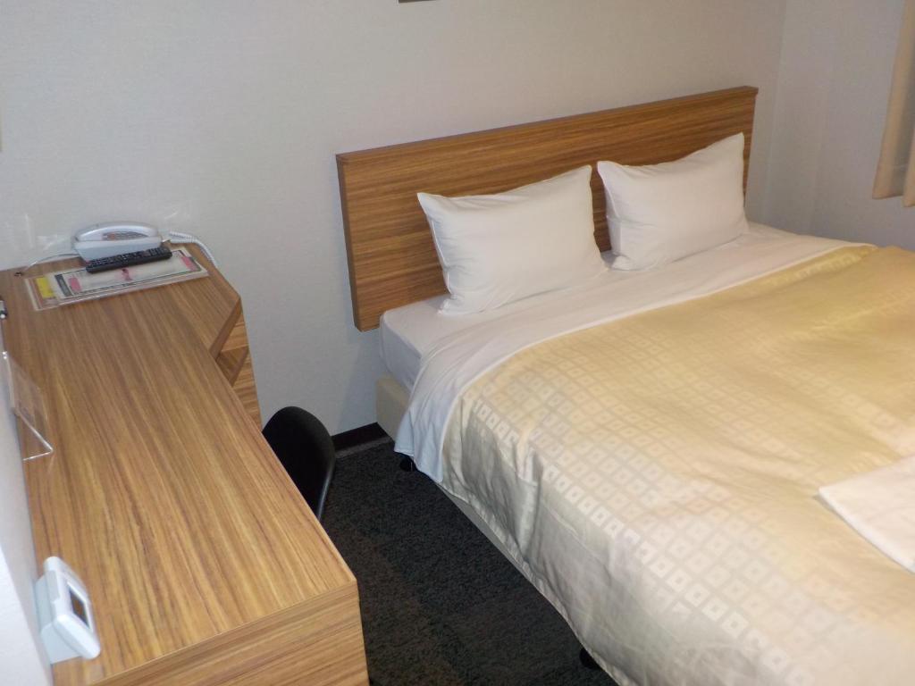 Postel nebo postele na pokoji v ubytování Hotel Crown Hills Katsuta Nigo Motomachiten
