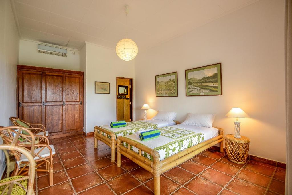 Postel nebo postele na pokoji v ubytování Bukit Asri Lodge