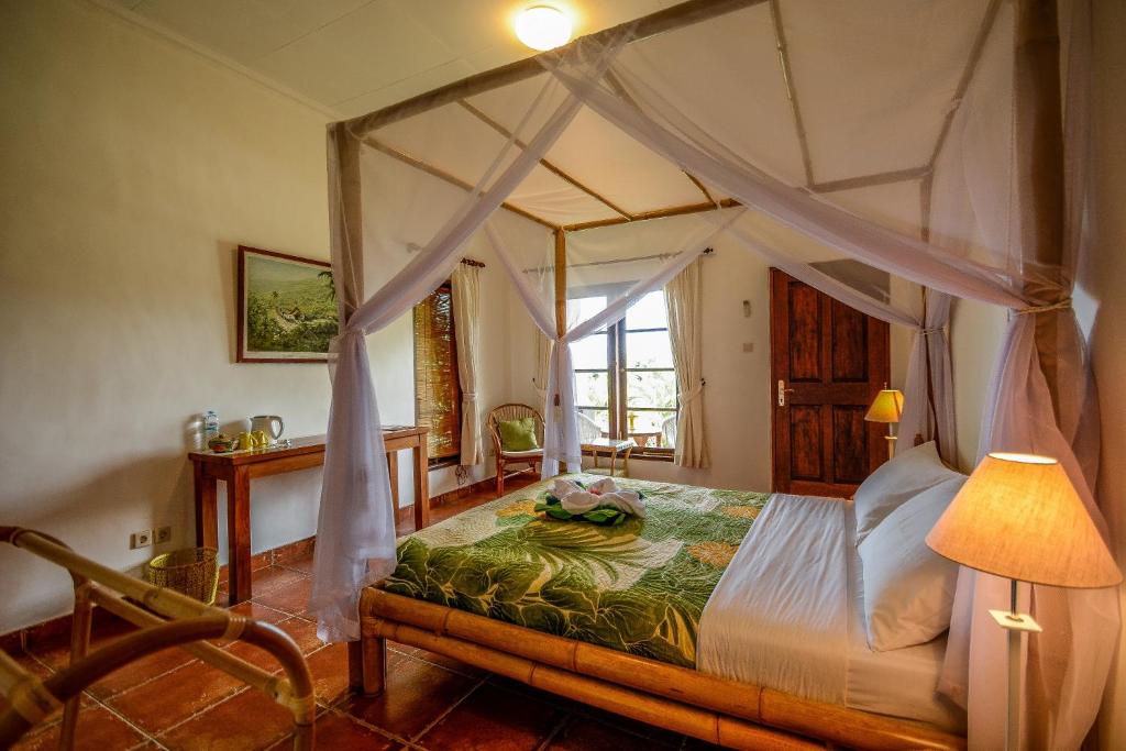 Postel nebo postele na pokoji v ubytování Bukit Asri Lodge