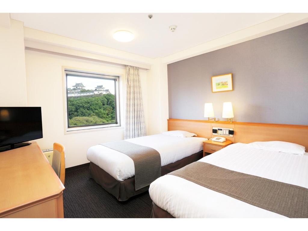 Postel nebo postele na pokoji v ubytování Smile Hotel Wakayama