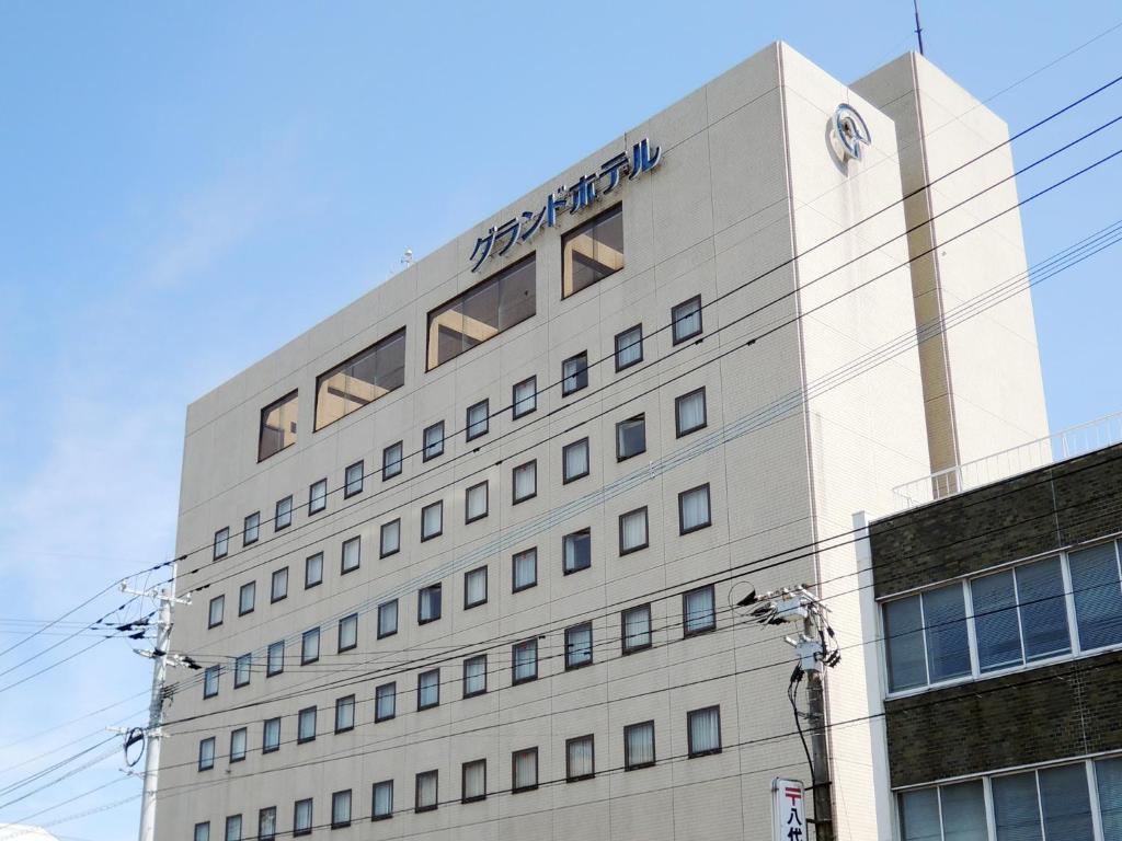 a building with a sign on the side of it at Yatsushiro Grand Hotel in Yatsushiro
